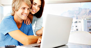 Electronic Billing Reduces Paper Waste | Couple at Laptop
