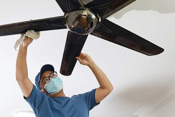 Ceiling Fan Shopping Tips | Man installing