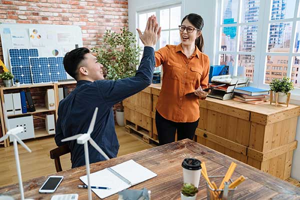 Renewable Energy Benefits - At work high-five image