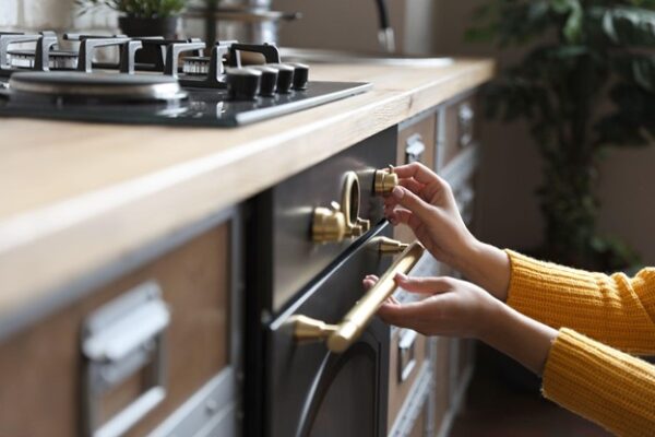 Woman Turns Down Gas on Oven Woman Turns Down Gas on Oven