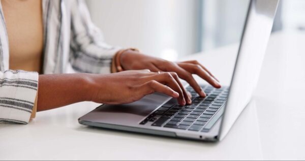 A woman's hands on a keyboard