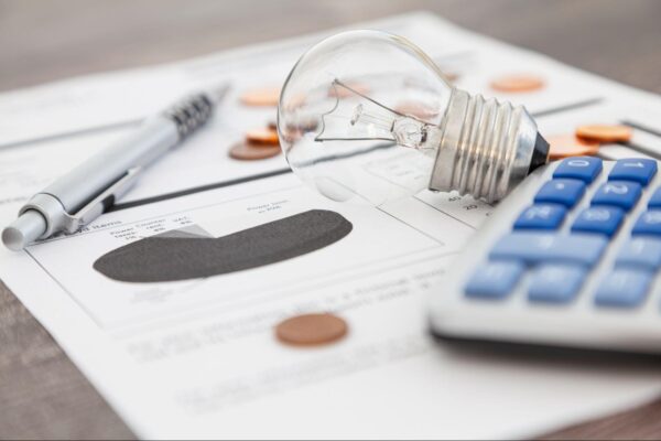 an image of a bill with a pen, calculator, and more