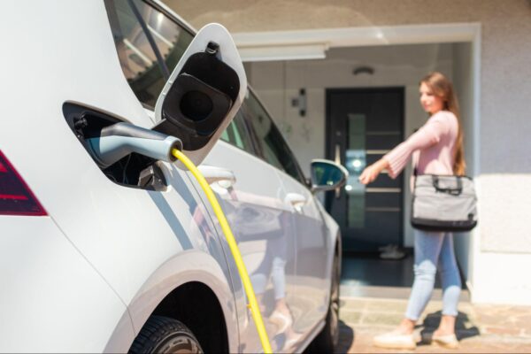 person-ev-charging a person charging an ev battery at their home